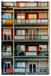Photograph by Richard Heeps. A colourful set of walls and balconies over five floors.