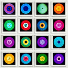Load image into Gallery viewer, Photograph by Heidler and Heeps. A set of 16 colourful vinyls in white frames, set out in a 4 x 4 format.