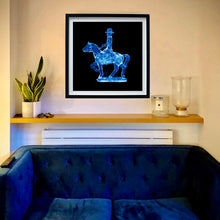 Load image into Gallery viewer, Cowboy on a horse blue pop art black frame on the living room wall photograph by Natasha Heidler.