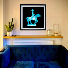 Load image into Gallery viewer, Cowboy on a horse blue pop art small photographic print framed in black by Natasha Heidler on the living room wall