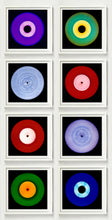 Load image into Gallery viewer, Photograph by Heidler and Heeps. Eight colourful vinyl records in white frames sit vertically, 2 x 4.