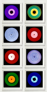 Photograph by Heidler and Heeps. Eight colourful vinyl records in white frames sit vertically, 2 x 4.