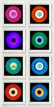 Load image into Gallery viewer, Photograph by Heidler and Heeps. Eight colourful vinyl records in white frames sit vertically, 2 x 4.