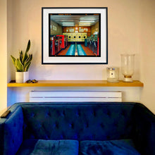 Load image into Gallery viewer, In situ photograph by Richard Heeps. A laundrette with washing machines on each wall and a double sided seat in the middle.