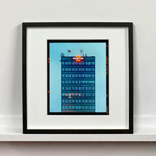 Load image into Gallery viewer, Black framed photograph by Richard Heeps. High rise offices in a blue light with Martini logo on the top facade.