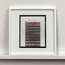 Load image into Gallery viewer, White framed photograph by Richard Heeps. High rise offices with Martini logo on the top facade.