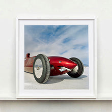 Load image into Gallery viewer, White framed photograph by Richard Heeps.  The side on front of a red belly tank racing car, it is designed as a shark eating a $100 bill.