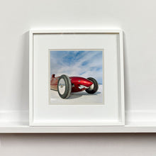Load image into Gallery viewer, White framed photograph by Richard Heeps.  The side on front of a red belly tank racing car, it is designed as a shark eating a $100 bill.