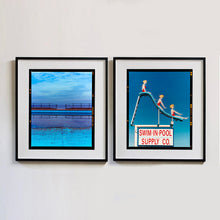 Load image into Gallery viewer, Two photographs by Richard Heeps. The photograph on the left hand side depicts the blue bay at Llandudno, cut across the middle with path and railings with a gap right in the middle. The photograph on the right hand side is a metal neon sign showing three women with blonde hair and red swimsuits at different stages down a swimming pool slide. At the bottom of the sign is written SWIM-IN-POOL SUPPLY CO