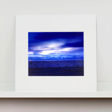 Load image into Gallery viewer, Mounted photograph by Richard Heeps. A blue light hits vast land, mountains and a big sky.