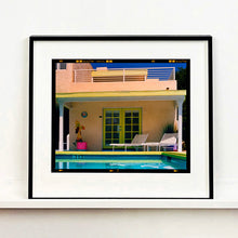 Load image into Gallery viewer, Black framed photograph by Richard Heeps. Palm Springs Pool Side II showcases classic mid-century Palm Springs California architecture. Cool blue skies and pool with accents of pink and almost neon yellow.
