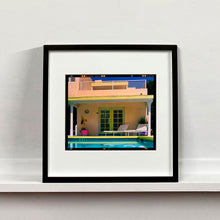 Load image into Gallery viewer, Black framed photograph by Richard Heeps. Palm Springs Pool Side II showcases classic mid-century Palm Springs California architecture. Cool blue skies and pool with accents of pink and almost neon yellow.
