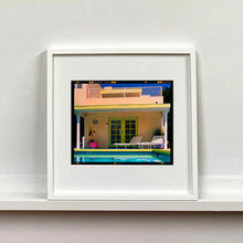 Load image into Gallery viewer, White framed photograph by Richard Heeps. Palm Springs Pool Side II showcases classic mid-century Palm Springs California architecture. Cool blue skies and pool with accents of pink and almost neon yellow.