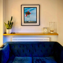 Load image into Gallery viewer, In situ photograph by Richard Heeps edged by film rebate. A roadside sign on Route 66 in America. The word ROY'S appears in a black sign with a bit red arrow pointing to the left ground, below this VACANCY and on a green square the words MOTEL and CAFE.