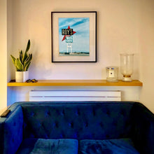 Load image into Gallery viewer, Photograph by Richard Heeps in situ. A roadside sign on Route 66 in America. The word ROY'S appears in a black sign with a big red arrow pointing to the left ground, below this VACANCY and on a green square the words MOTEL and CAFE.