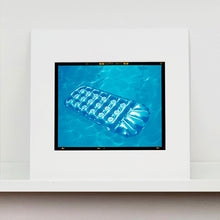 Load image into Gallery viewer, Mounted photograph by Richard Heeps. A transparent blue lilo is sun bathing on a blue pool.