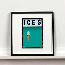Load image into Gallery viewer, Black framed photograph by Richard Heeps.  At the top black letters spell out ICES and below is depicted a 99 icecream cone sitting left of centre against a Turquoise Teal coloured background.