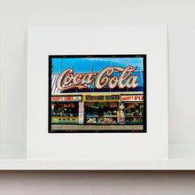 Load image into Gallery viewer, Mounted photograph by Richard Heeps. Harry's Corner was taken on the wildwood boardwalk, featuring neon typography and the iconic Coca-Cola sign against a bright blue sky.
