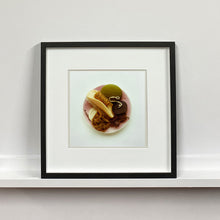 Load image into Gallery viewer, Black framed photograph by Richard Heeps. A vintage pink soap dish sits on a white surface. Looking down onto the soap dish which contains two plugs, green soap, nail brush, cork and a sponge/wire wool combo.