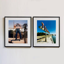 Load image into Gallery viewer, Two black framed photographs side by side by Richard Heeps. The photograph on the left hand side, the headless torso of a giant fibreglass sculpture of a cowboy (a Muffler Man). The photograph on the right hand side is a retro Texaco sign.