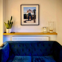 Load image into Gallery viewer, In situ black framed photograph by Richard Heeps. The headless torso of a giant fibreglass sculpture of a cowboy (a Muffler Man).