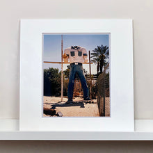 Load image into Gallery viewer, Mounted photograph by Richard Heeps. The headless torso of a giant fibreglass sculpture of a cowboy (a Muffler Man).