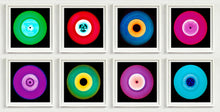 Load image into Gallery viewer, Photograph by Heidler and Heeps. Eight colourful vinyl records in white frames sit horizontally, 2 x 4.