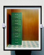 Load image into Gallery viewer, This green filing cabinet stands in the corner of a mid-century wood panelled bunker office. This interior artwork was photographed in Ho Chi Minh City, and is part of Richard&#39;s series &#39;This is not America&#39;.