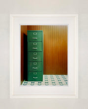 Load image into Gallery viewer, This green filing cabinet stands in the corner of a mid-century wood panelled bunker office. This interior artwork was photographed in Ho Chi Minh City, and is part of Richard&#39;s series &#39;This is not America&#39;.