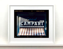 Load image into Gallery viewer, Cordial Campari, photographed as part of Richard Heeps’ series 'A Short History of Milan’ features beautiful and bold typography above the striped awning of a fascist building.