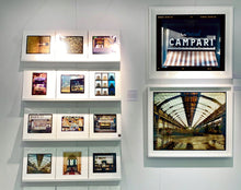 Load image into Gallery viewer, Cordial Campari, photographed as part of Richard Heeps’ series 'A Short History of Milan’ features beautiful and bold typography above the striped awning of a fascist building.