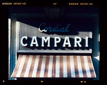 Load image into Gallery viewer, Cordial Campari, photographed as part of Richard Heeps’ series 'A Short History of Milan’ features beautiful and bold typography above the striped awning of a fascist building.