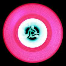 Load image into Gallery viewer, Photograph by Natasha Heidler and Richard Heeps.  A pink vinyl record with thin white grooves and a white label sits on a black background.