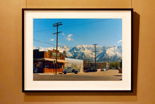 Load image into Gallery viewer, There is a cinematic style to this artwork, 'Lone Pine', taken in a former movie town in California where many Western films were made. Taken outside Richard's iconic interior photograph 'Bonanza Café', set in the Owens Valley against a mountainous  backdrop.