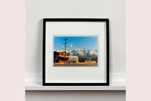 Load image into Gallery viewer, There is a cinematic style to this artwork, 'Lone Pine', taken in a former movie town in California where many Western films were made. Taken outside Richard's iconic interior photograph 'Bonanza Café', set in the Owens Valley against a mountainous  backdrop.