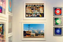 Load image into Gallery viewer, There is a cinematic style to this artwork, 'Lone Pine', taken in a former movie town in California where many Western films were made. Taken outside Richard's iconic interior photograph 'Bonanza Café', set in the Owens Valley against a mountainous  backdrop.