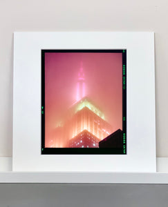 'NOMAD III (Film Rebate)', New York. Richard Heeps has photographed the iconic Empire State building in the mist. The NOMAD sequence of photographs capture the art deco architecture illuminated by changing colours, and is part of Richard's street photography portfolio which depict the colour, fabric and structure of cities with distinct style. This 6x7 format edition is bordered by the Kodak film rebate.