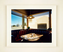Load image into Gallery viewer, 'Nicely's Cafe' taken in Mono Lake, California, is a cinematic and classic American Diner scene photographed by Richard Heeps for his 'Dream in Colour' series. "I was driving between Death Valley and Fallon when I stopped at this Diner for a coffee. The light was perfect."