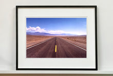 Load image into Gallery viewer, 'The Road to Death Valley', taken in the Majove Desert, California, features a clouded blue sky met my mountains on the horizon. This American landscape artwork is part of Richard Heeps' 'Dream in Colour' series. Taken in 2001, this artwork was first executed in Richard's darkroom in 2021.