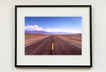 Load image into Gallery viewer, 'The Road to Death Valley', taken in the Majove Desert, California, features a clouded blue sky met my mountains on the horizon. This American landscape artwork is part of Richard Heeps' 'Dream in Colour' series. Taken in 2001, this artwork was first executed in Richard's darkroom in 2021.