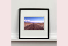 Load image into Gallery viewer, 'The Road to Death Valley', taken in the Majove Desert, California, features a clouded blue sky met my mountains on the horizon. This American landscape artwork is part of Richard Heeps' 'Dream in Colour' series. Taken in 2001, this artwork was first executed in Richard's darkroom in 2021.