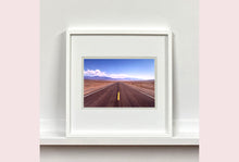 Load image into Gallery viewer, 'The Road to Death Valley', taken in the Majove Desert, California, features a clouded blue sky met my mountains on the horizon. This American landscape artwork is part of Richard Heeps' 'Dream in Colour' series. Taken in 2001, this artwork was first executed in Richard's darkroom in 2021.