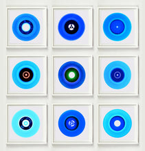 Load image into Gallery viewer, Photograph by Heidler and Heeps. A set of 9 different blue vinyls in white frames. They are displayed in a square 3 x 3 format.