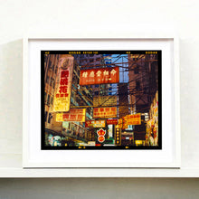 Load image into Gallery viewer, Best Choice in Downtown, Hong Kong cityscape skyline architecture street photography by Richard Heeps framed in white.