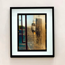 Load image into Gallery viewer, Call Box, cinematic vintage telephone booth road trip mounted photograph in a black frame from Richard Heeps Salton Sea series.