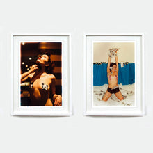 Load image into Gallery viewer, Two white framed burlesque photographic prints by Richard Heeps hanging side by side on a light gray wall. 
