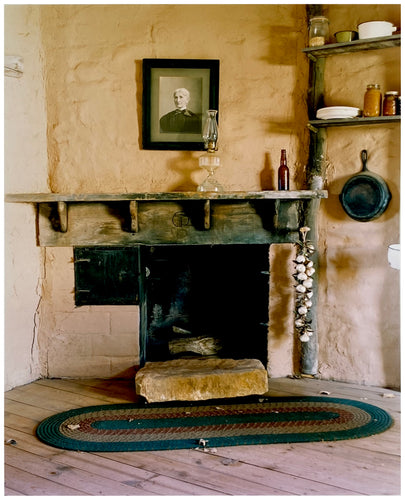 Photograph by Richard Heeps. Film set of 'The Outlaw Josey Wales' featuring a wooden fireplace and a black and white photo over the mantlepiece.
