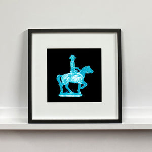 Cowboy on a horse blue pop art small photographic print framed in black by Natasha Heidler