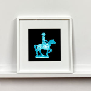 Cowboy on a horse blue pop art small photographic print framed in white by Natasha Heidler