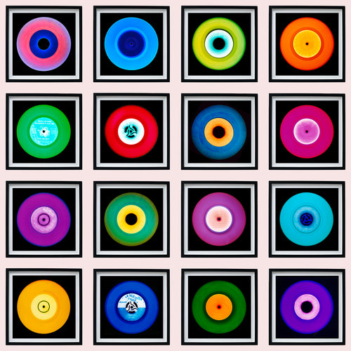 Photograph by Heidler and Heeps. A set of 16 colourful vinyls in black frames, set out in a 4 x 4 format.